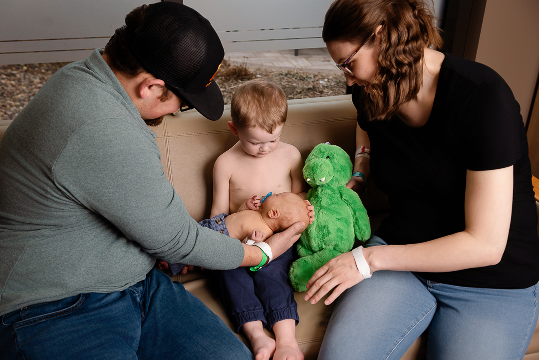 Boy meetings newborn sibling