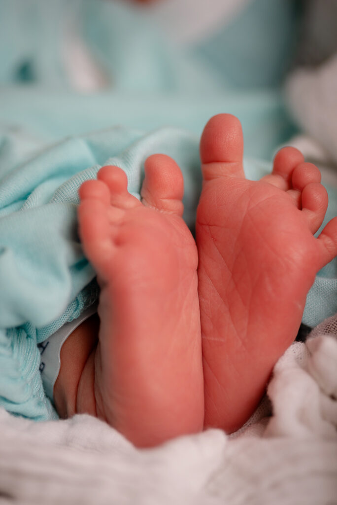 Newborn baby peacefully sleeping in wooden bowl prop during studio photography session