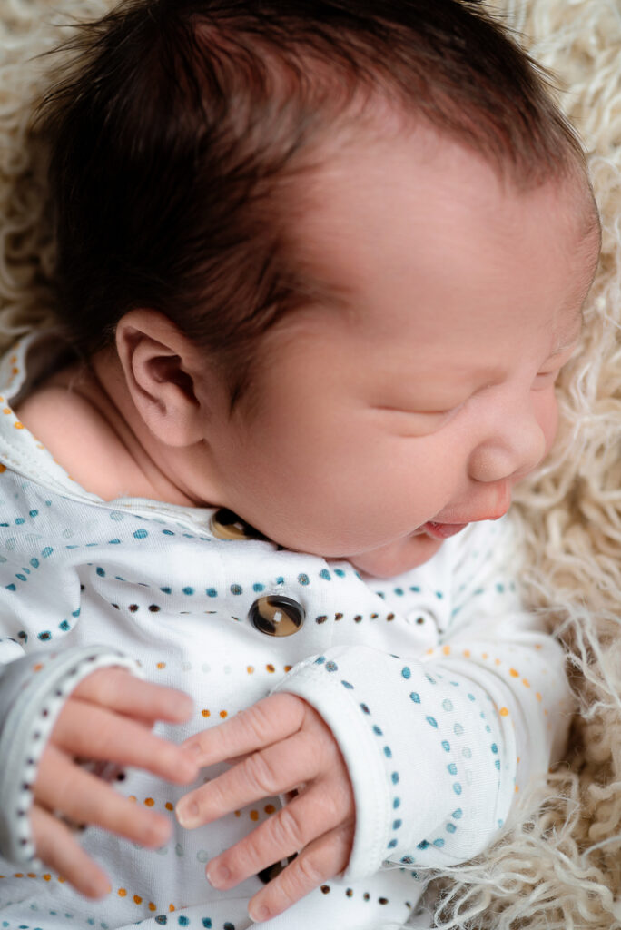 Mother holding newborn during heartfelt lifestyle photography session in New Richmond Wisconsin