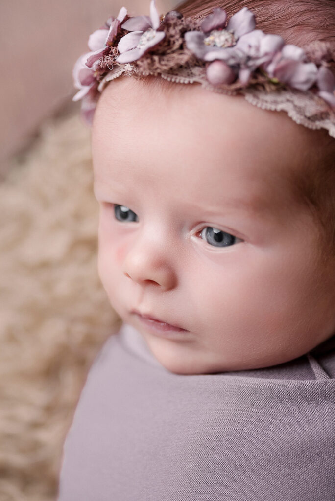 Soft, natural newborn portrait created with safe posing and minimal styling