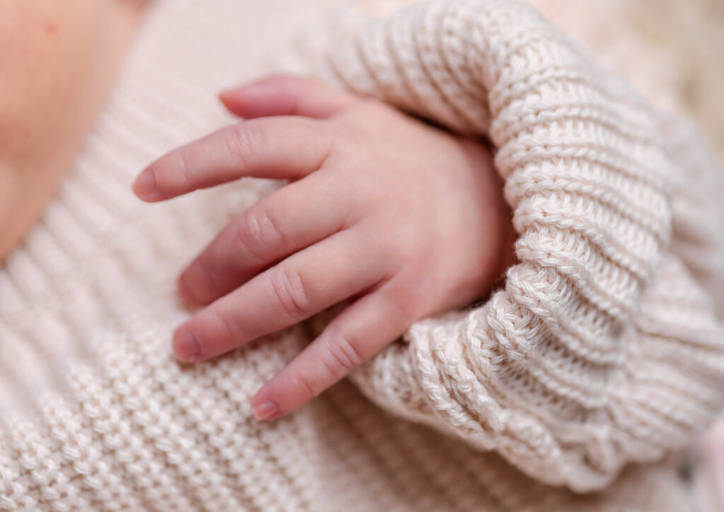Close-up of newborn hands and details captured in a baby-led photography session